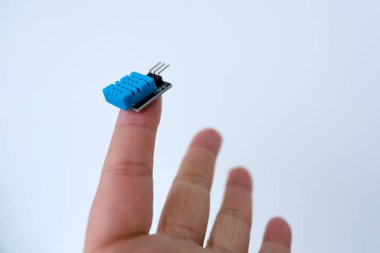 microchip on finger of female hand on white background, research, development of microelectronics and processors, concept future technologies aimed tracking and identifying people, nanotechnology