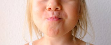 part of face happy funny small child, blonde girl 3 years old chews food with a smile, kid has good appetite, happy childhood, balanced diet, sweet life, healthy food, halal food