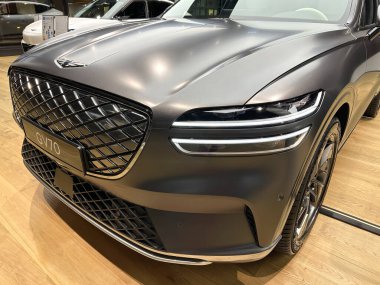 mercury metallic Hyundai Genesis GV70 combined engines car model in Studio Frankfurt, korean passenger Electric SUV vehicle in showroom, electric energy consumption concept, Frankfurt - January 2023