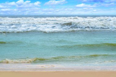 blue sea, turquoise waves rush to shore, beautiful tropical seascape, ocean storming, sky with clouds, concept water sports, travel tropics, surf season, danger rip currents, background for designer