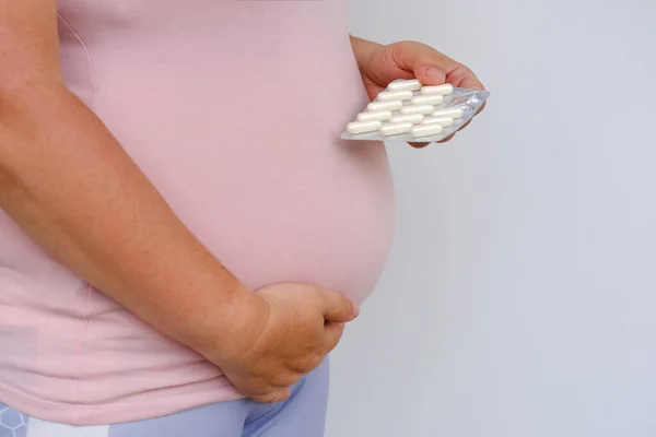 Pregnant Woman Holds Drugs Vitamins Hand Belly Concept Influence Pharmacology — Fotografie, imagine de stoc