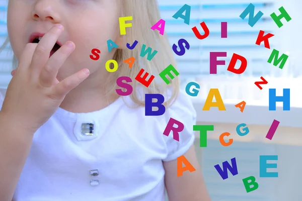 scattering of different letters against background of girl 3 years old, speech disorders, dyslexia awareness, help children with reading, learning difficulties, human brain development concept