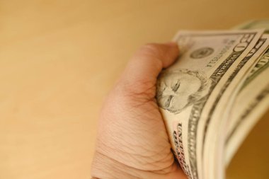 female hand holds pack American dollars banknotes, concept payments, savings, banking, save for vacation, cash out currency, get passive income, social assistance poor, monetary recession, inflation