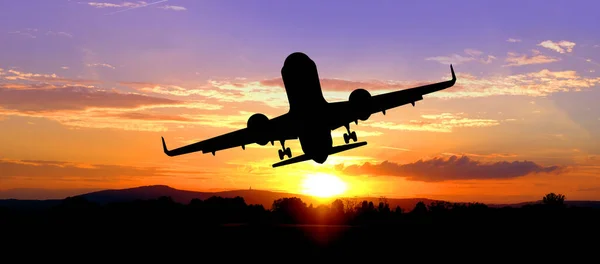 black silhouette of airplane in beautiful colorful dramatic sky with cloud, handsome sunset, concept flight in heavenly space, meditative calmness and greatness, transportation, cargo transportation