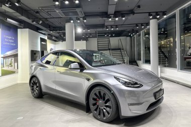 Tesla car model Y in liquid silver dubbed Mercury Silver Metallic color in Studio, electric vehicle in showroomr, alternative energy development concept, Elon Musk company, Frankfurt - January 2023