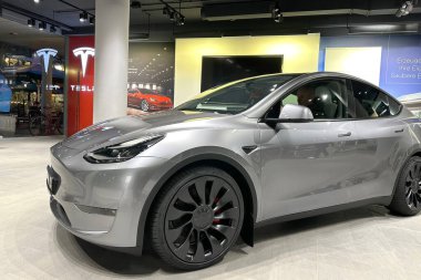 Tesla car model Y in liquid silver dubbed Mercury Silver Metallic color in Studio, electric vehicle in showroomr, alternative energy development concept, Elon Musk company, Frankfurt - January 2023