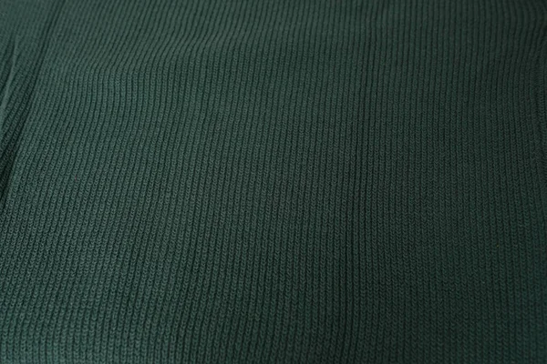 knitted jersey, embossed canvas, green wool yarn, knitted texture, concept of warm things for cold weather, check quality, fashionable clothes, clothing production