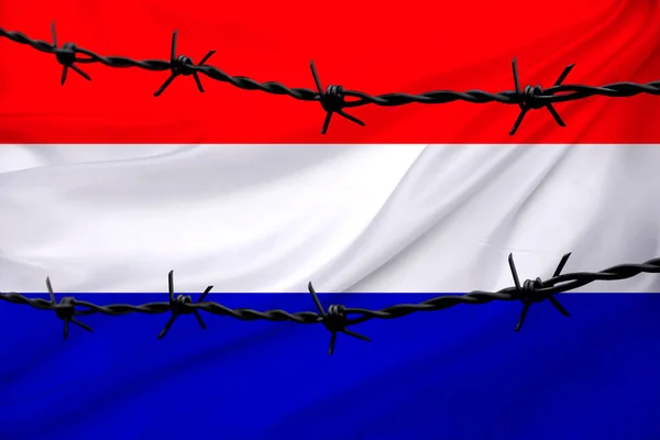 stock image national flag of Netherlands on textured background, rows of barbed wire, concept of war, revolution, armed uprising in country, increase in crime in state, terrorist attack, redistribution of power