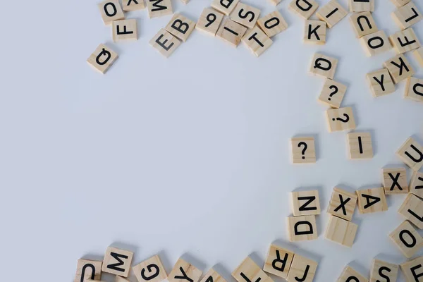 stock image close-up of scattering of wooden squares with letters, empty space for the designer, light background, quantitative indicator expressing success, concept of mind level