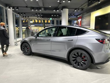 Tesla car model Y in liquid silver dubbed Mercury Silver Metallic color in Studio, electric vehicle in showroomr, alternative energy development concept, Elon Musk company, Frankfurt - January 2023