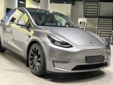 Tesla car model Y in liquid silver dubbed Mercury Silver Metallic color in Studio, electric vehicle in showroomr, alternative energy development concept, Elon Musk company, Frankfurt - January 2023