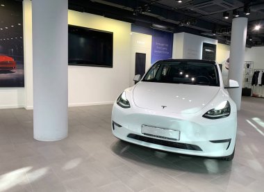 white Tesla car model Y in Studio Frankfurt, popular passenger electric vehicle in showroomr, alternative energy development concept, Elon Musk, Tesla is American company, Frankfurt - January 2023