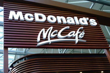 large modern signboard, McDonald's logo in lobby of airport, beautiful geometric background, three-dimensional letters, concept travel, voyage, fast food, eat between flights, Frankfurt - August 2022