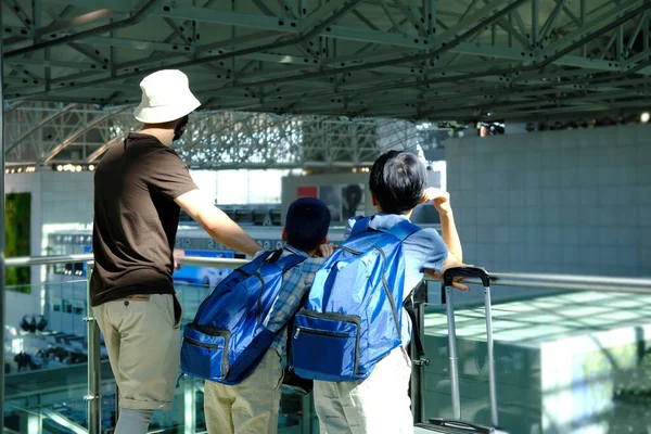 Man Two Children Backpacks Suitcase Travelers Standing Lobby Beautiful Modern —  Fotos de Stock