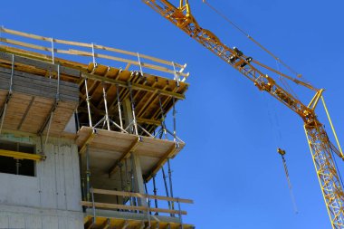construction site, metal assembly scaffolding near walls of new multi-storey building, building materials, housewarming, mortgage for new housing, modern civil engineering, construction crane