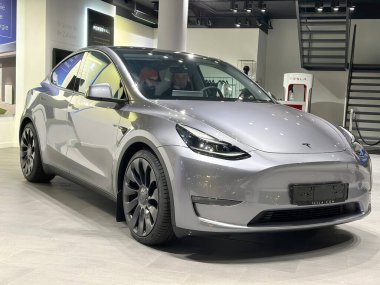 Tesla car model Y in liquid silver dubbed Mercury Silver Metallic color in Studio, electric vehicle in showroomr, alternative energy development concept, Elon Musk company, Frankfurt - January 2023