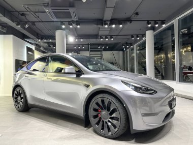 Tesla car model Y in liquid silver dubbed Mercury Silver Metallic color in Studio, electric vehicle in showroomr, alternative energy development concept, Elon Musk company, Frankfurt - January 2023