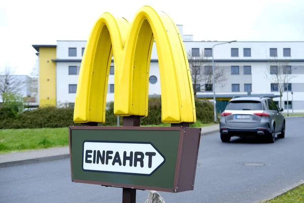 stock image yellow signboard, McDonald's logo on street, fastfood restaurant chain, American corporation operating in food service industry, delivery partner, travel fast food, car traveling, Frankfurt - May 2023