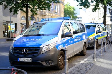 police cars on streets of germany, law enforcement officers guarding order on vehicles, patrolling, sending law enforcement officers to incident or crime, investigating crimes, Frankfurt - August 2022