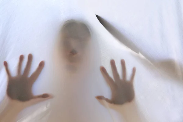 eerie blurry hands and face of girl, killer knife silhouette, victim of violence behind window, dense fabric, wrap, ghost, spirit trying to reach out from afterlife, concept of friday 13th