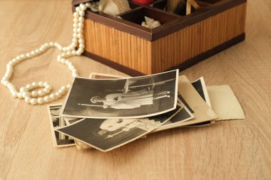 stack of old retro family sepia photos on table, vintage wooden box with dear heart memorabilia, concept of family tree, genealogy, home archive, memory of ancestors, childhood memories clipart