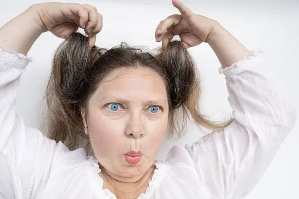 Close Cheerful Girl Fooling Lifting Hair Making Expressive Facial Expressions — Stock Photo, Image