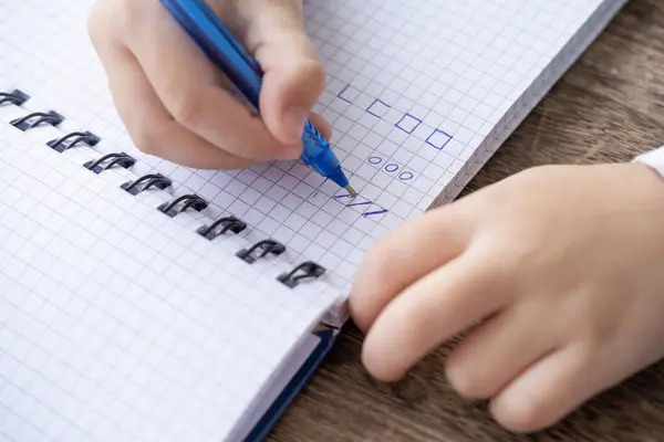 Child Hand Writes Pen Checkered Notebook Practicing Handwriting Preschooler Hand — Stock Photo, Image
