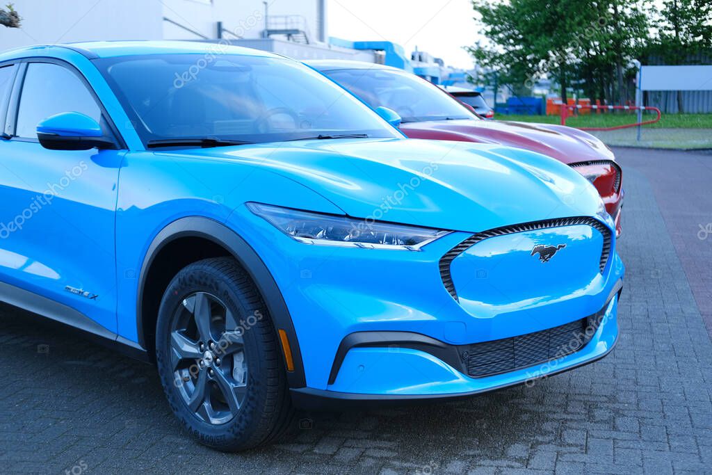 Electric Ford Mustang Mach-E on display in parking lot of company store specializing in sale of electric vehicles, alternative energy, Frankfurt - May 27, 2023
