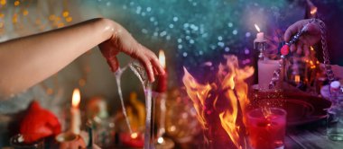 Librate with pendulum, healing or oracle foretelling, magic session, Female Fortuneteller or esoteric Oracle performs spell, shakes charmed amulet, talisman for good luck, money, removes damage