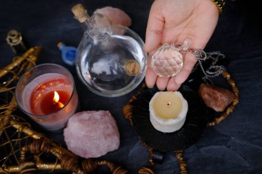 Ruhsal Salon Deneyimi, ezoterik masa, kadın falcının el ele tutuşması ve cam top kristali, mum yakma, büyü kavramı, cadılık sırları.