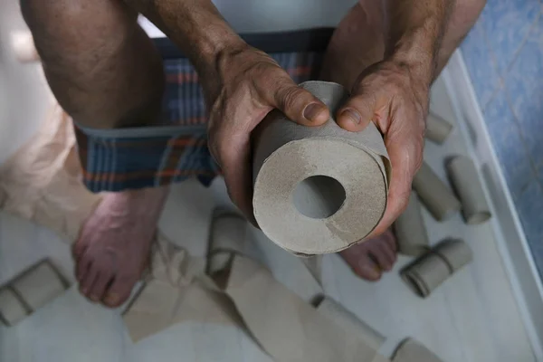 man suffering from diarrhea holds roll of toilet paper while sitting on toilet, gastrointestinal problems, health of gastrointestinal tract and prevent problems