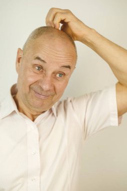 close-up male face, mature man 60 years old, senior seriously looking away, distressed, shocked by news, thinks about problems, stress piled up, concept of human health, reflections on meaning of life