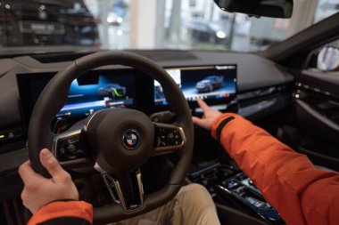 BMW i5 eDrive40 kullanan adam, dijital panel, iç mekan, kokpit modern EV, erkek eller direksiyonda, sürücü güvenliği, Avrupa 'da çevre aracı, Frankfurt, Almanya - 22 Ocak 2024