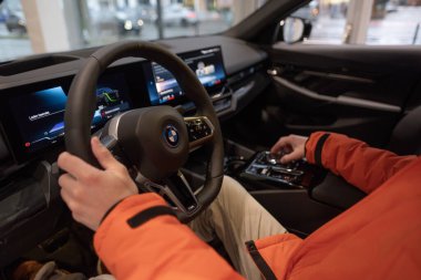 BMW i5 eDrive40 kullanan adam, dijital panel, iç mekan, kokpit modern EV, erkek eller direksiyonda, sürücü güvenliği, Avrupa 'da çevre aracı, Frankfurt, Almanya - 22 Ocak 2024