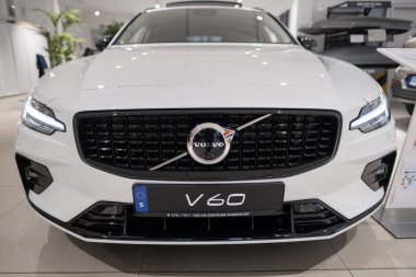 white new Volvo V60 cross country d4 awd, Swedish Plug-in Hybrid car, alternative energy development, High Tech Advanced technology in automotive industry show in Frankfurt, Germany - January 22, 2024 clipart