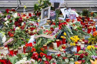 navalny memorial, flowers lie on ground, mourning candles burning after death Russian politician Alexei Navalny front Consulate General of Russian Federation, Berlin, Germany - February 18, 2024 clipart