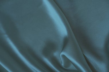 Yumuşak, nazik kıvrımlı turkuaz pastel renkte zarif ipek dokusu, tasarım konsepti, ipek kumaş arka planı, tasarımcı için kopya alanı, metin modeli