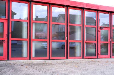 Fire truck garage with red doors in Germany, concept Emergency Services Infrastructure, Fire Safety, Technical Maintenance of Fire Trucks clipart