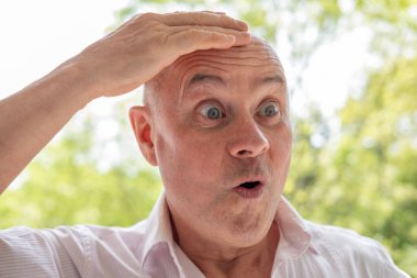 65 yaşındaki eksantrik adam çok şaşırdı, son sınıf öğrencisi somurtuyor, göz kırpıyor, haylaz sırıtıyor, hayatın saçmalıklarını kucaklıyor, komik tuhaf, kendisi olmaktan korkmayan ve kahkaha getiren biri.