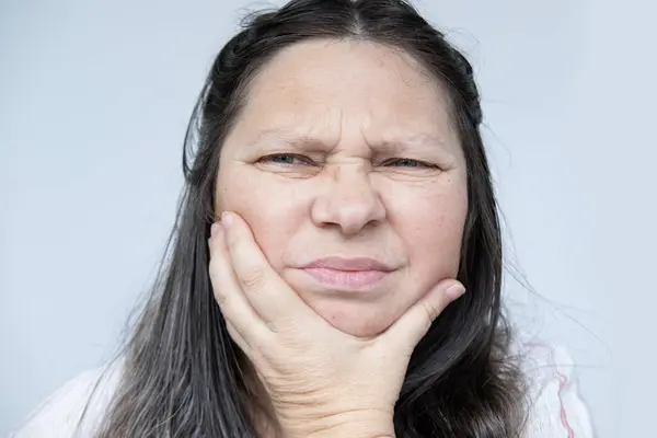 stock image caucasian mature woman face with gumboil, toothache, gum inflammation, painful Discomfort Health, Treatment and Care, Diagnosing and Treating