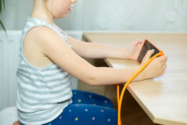 stock image young girl maintains good posture while using phone, sitting with straight back, healthy sitting, Normal healthy spine, spinal health