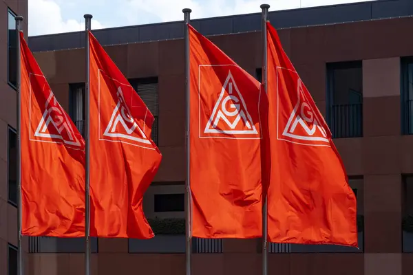 stock image Red IGM flags waving in wind with IG Metall logo prominently, German metalworkers union on building, Europe's largest industrial union, labor relations, national bargaining, Frankfurt - July 22, 2024