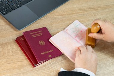 Close-up of female border patrol officers meticulously inspecting foreign passports, visa permits and stamping entry marks, Border Security and Control clipart