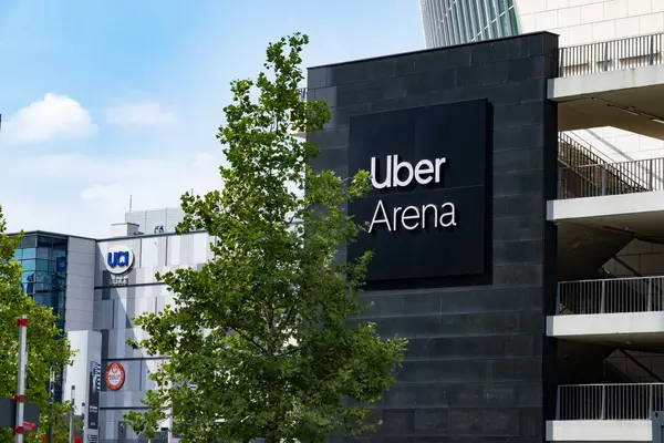 stock image Uber Eats Music Hall Advertising logo on modern building facade, fusion of food tech and music in bustling urban setting, Berlin, Germany - August 16, 2024