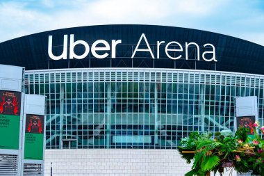 Uber Eats Music Hall Advertising logo on modern building facade, fusion of food tech and music in bustling urban setting, Berlin, Germany - August 16, 2024 clipart