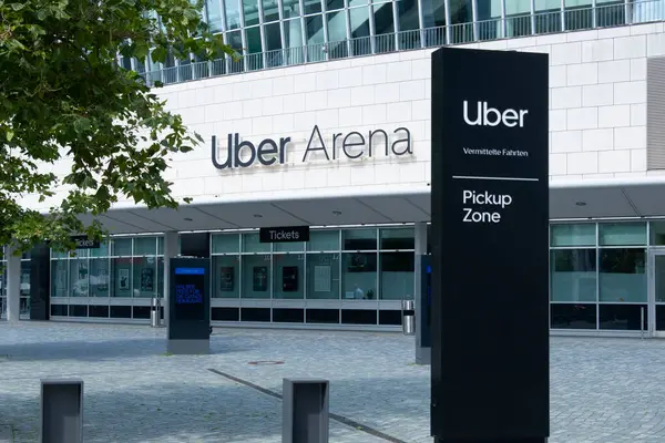 stock image Uber Eats Music Hall Advertising logo on modern building facade, fusion of food tech and music in bustling urban setting, Berlin, Germany - August 16, 2024