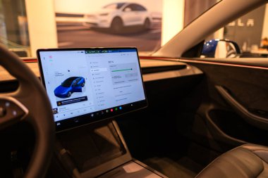 Minimalist gösterge paneli, direksiyon ve yüksek teknolojili dokunmatik ekran, üzerinde elektrikli mavi Tesla Model 3, Berlin - 20 Ağustos 2024