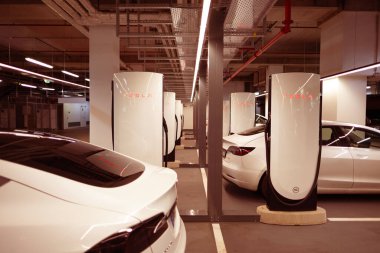 Tesla Supercharger station V4, future sustainable transportation, evolution electric vehicle infrastructure, future of urban mobility in Berlin - August 16, 2024 clipart