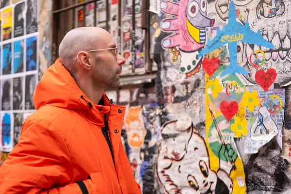 stock image young tourist man exploring city, Streetart Berlin, urban artwork, modern colourful drawing, tour tourism attraction, Street Art-Ikonen in Berlin - February 26, 2024