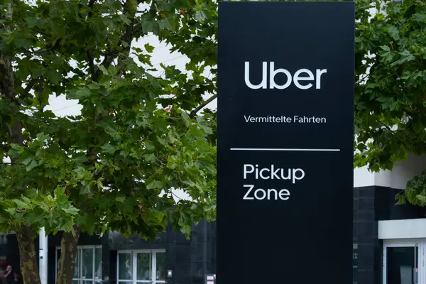 stock image Uber Eats Music Hall Advertising logo on modern building facade, fusion of food tech and music in bustling urban setting, Berlin, Germany - August 16, 2024